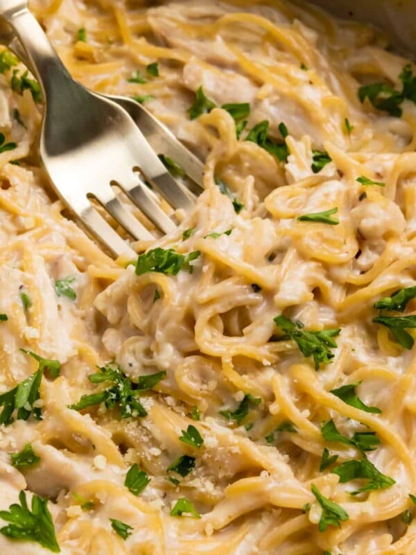 Chicken alfredo in pan with two forks.