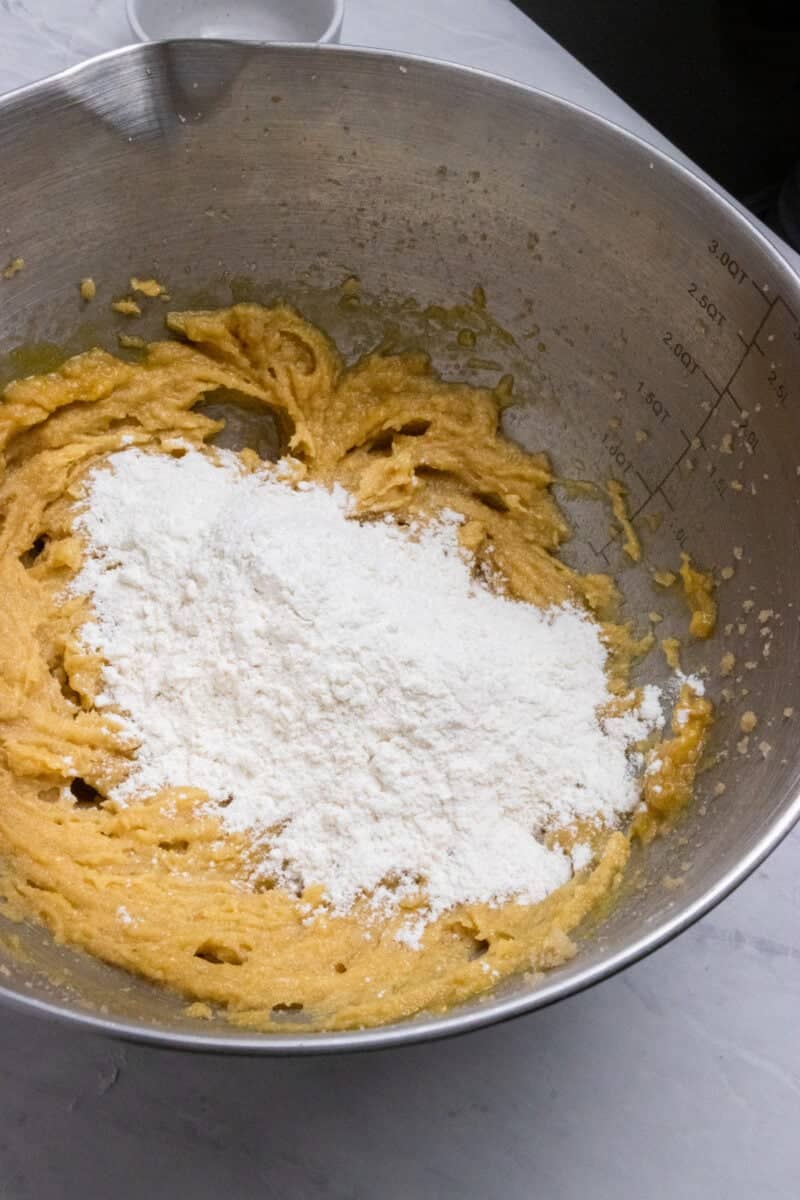 Flour and dry ingredients added to mixing bowl.