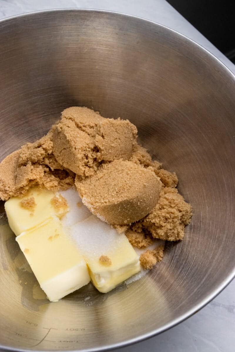 Butter, sugar and brown sugar in mixing bowl.