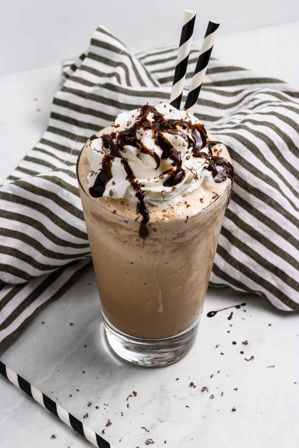 Ice blended coffee with straws and whipped cream.