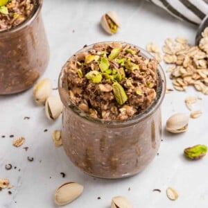 Pistachio oatmeal with chocolate in jar.