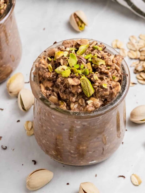 Pistachio oatmeal with chocolate in jar.