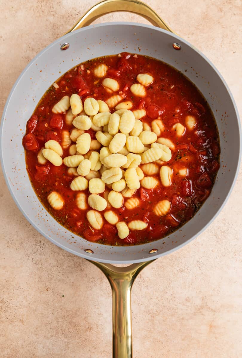 Gnocchi added to tomato mixture in skillet.
