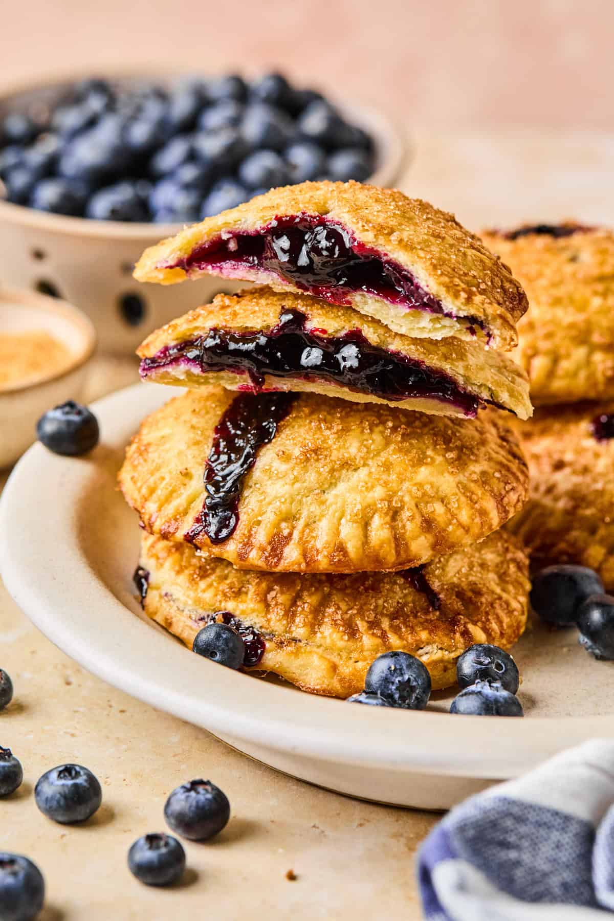 Plate with stacked air fryer hand pies with blueberry filling.