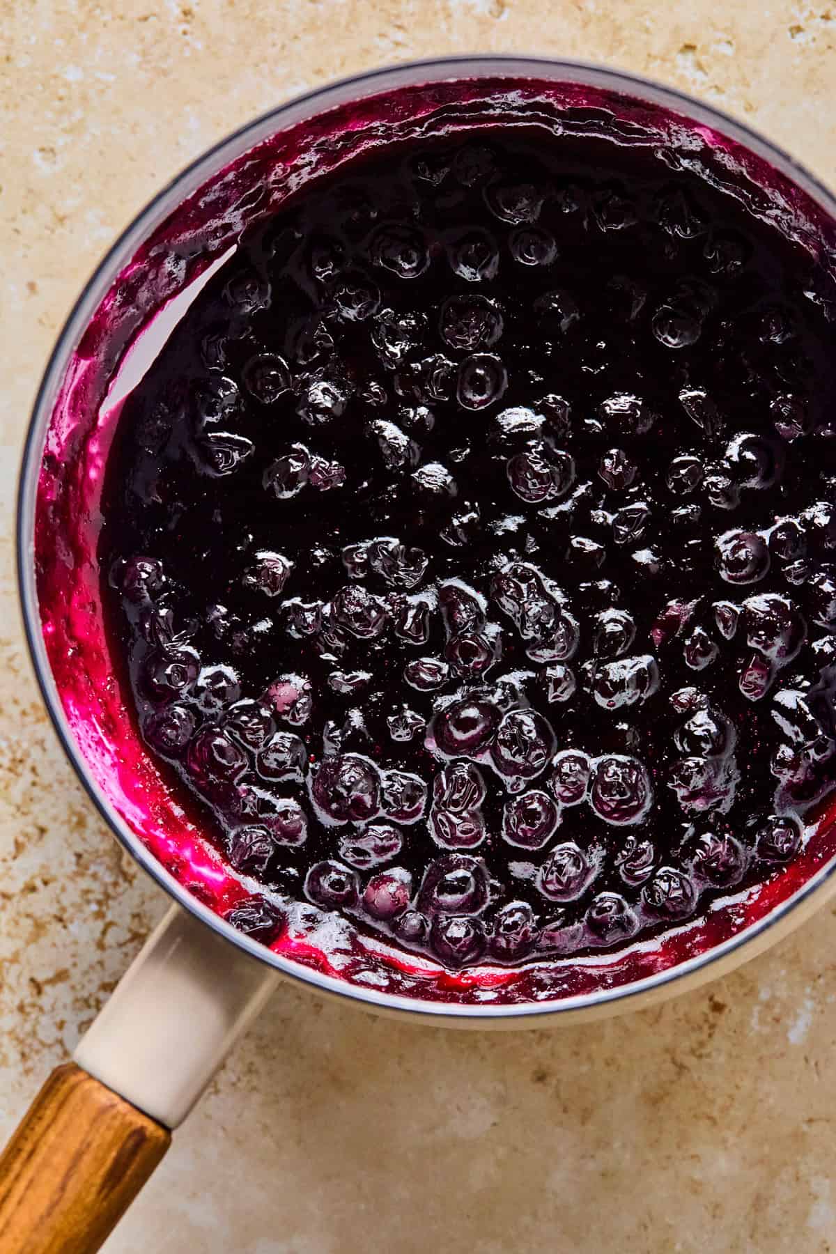 Blueberry sauce thickened in pot.