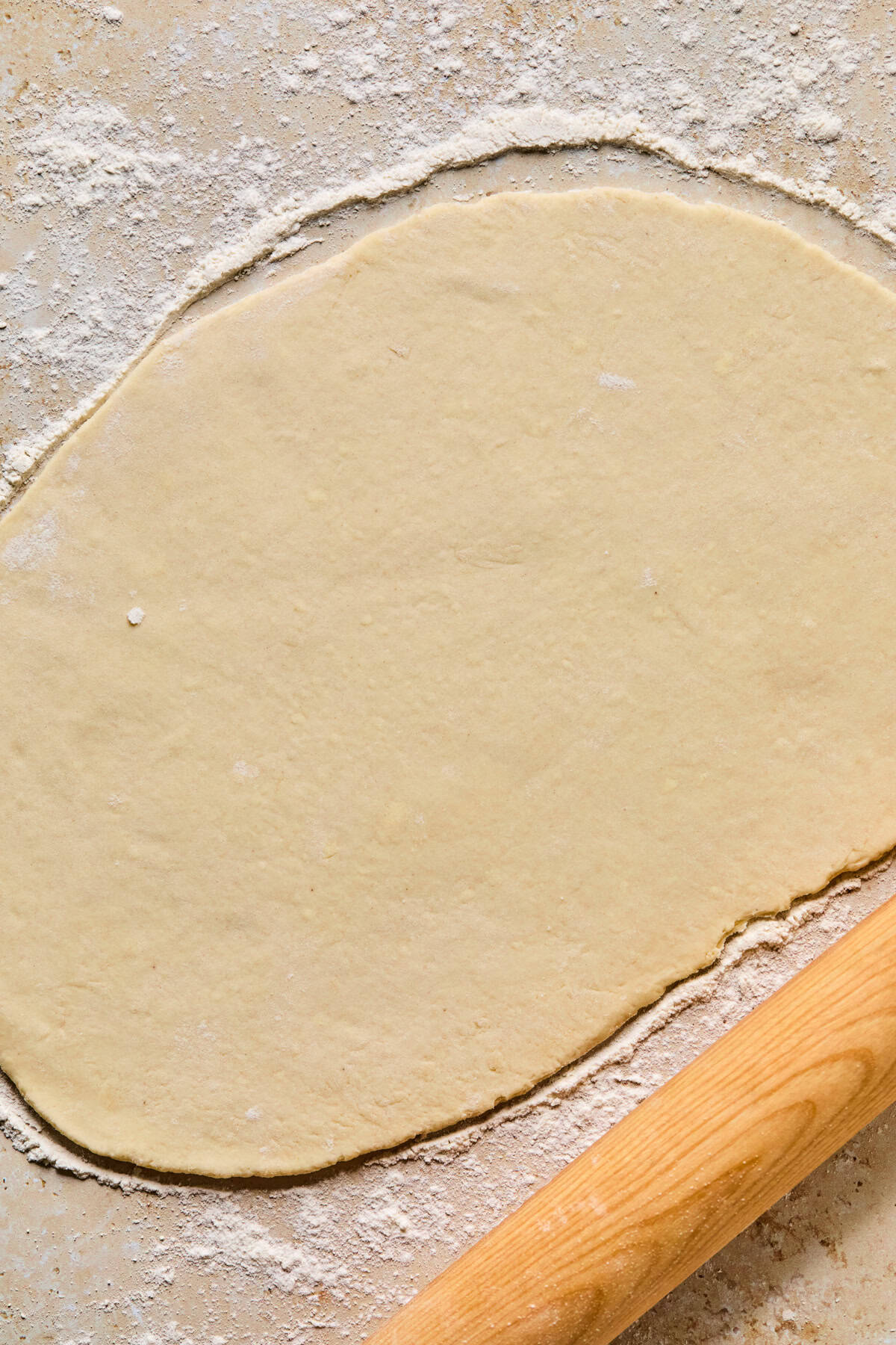 Pie crust rolled out on floured surface.