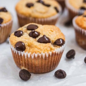 Almond flour banana muffin with chocolate chips on wax paper.
