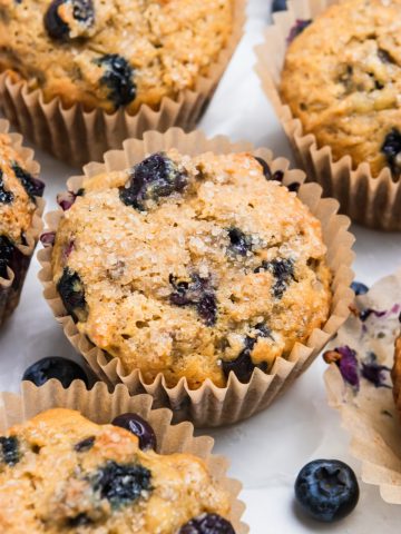 Banana blueberry muffins with blueberries on counter.