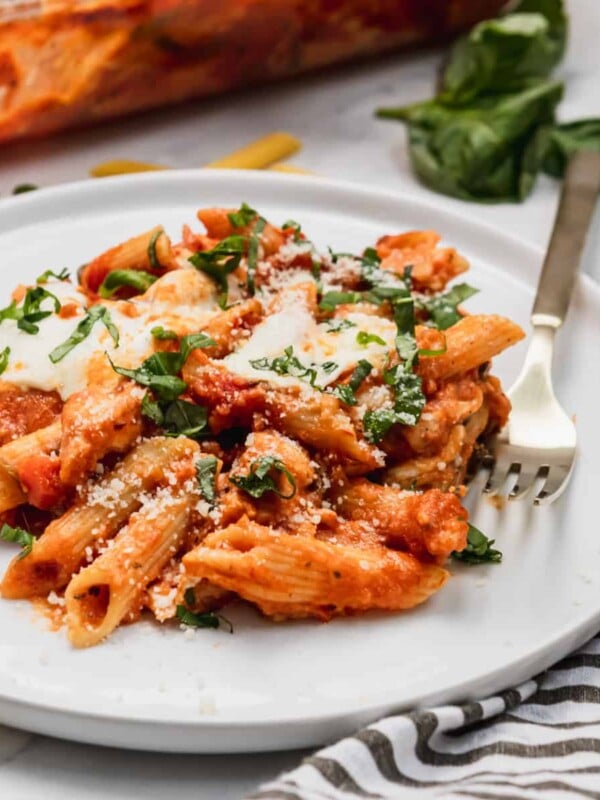 Chicken parmesan casserole on plate with fresh parsley.