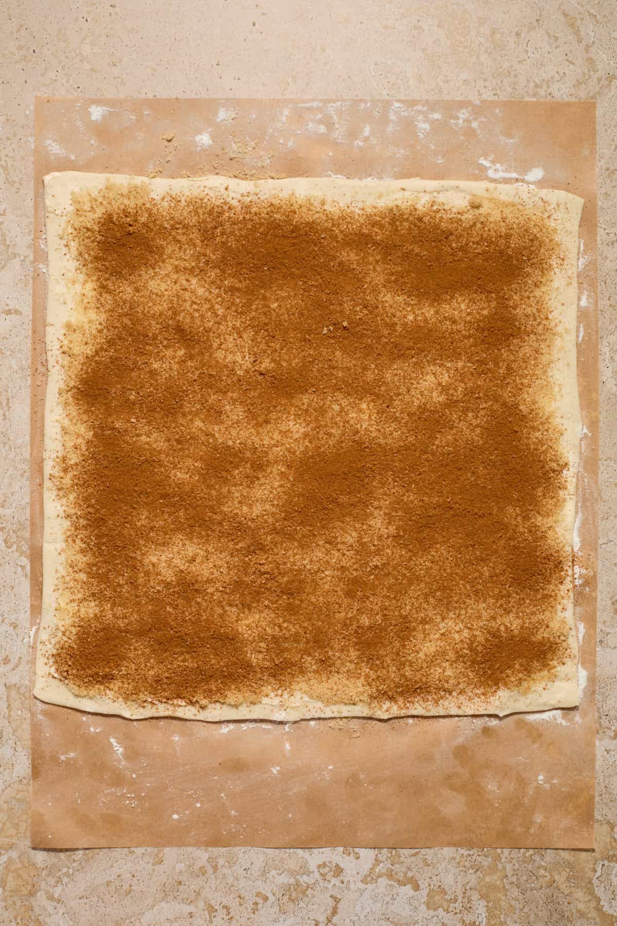 Brown sugar and cinnamon spread on puff pastry dough.