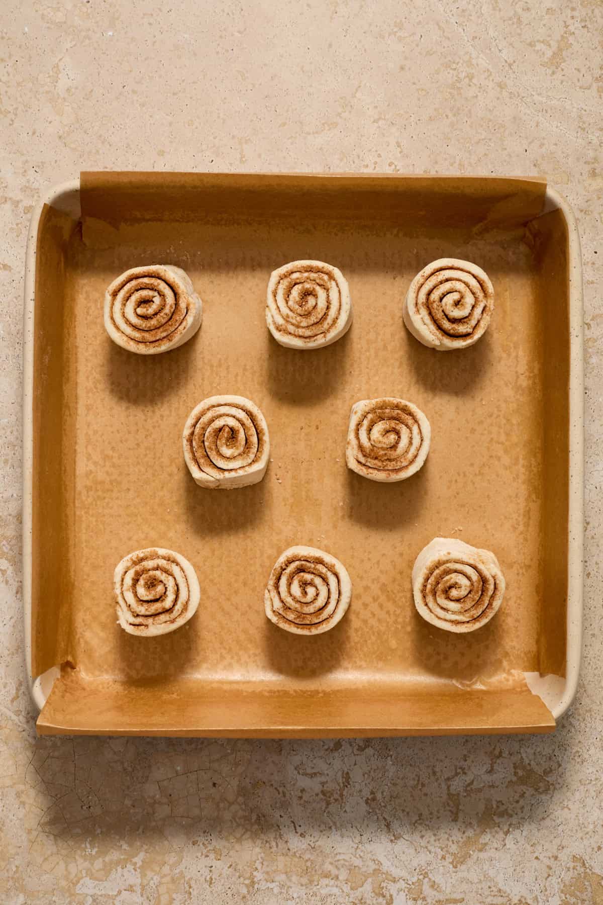Baking pan with prepped cinnamon rolls before baking.
