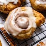 Puff Pastry Cinnamon roll with icing on cooing rack.