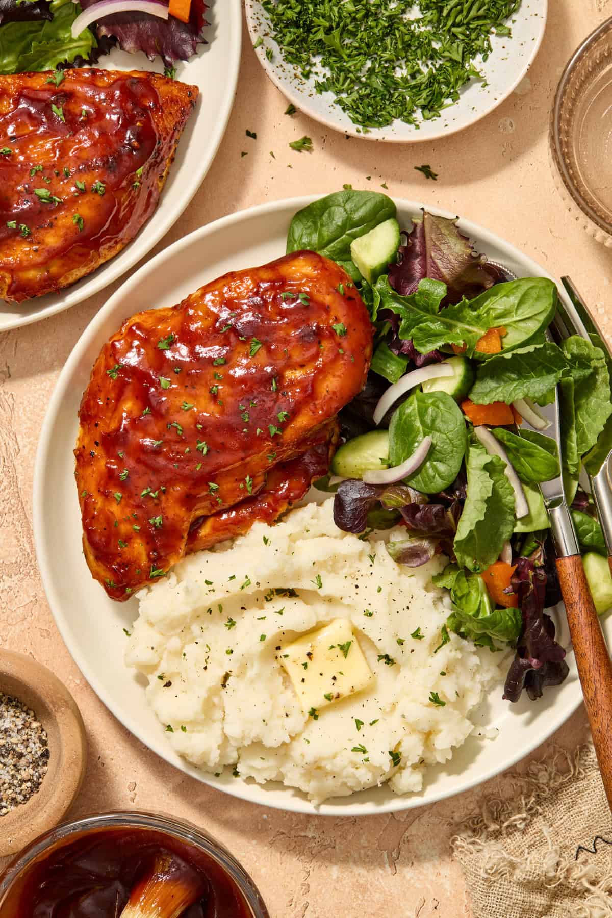 Air fryer bbq chicken breast served on plate with mashed potatoes and green salad.