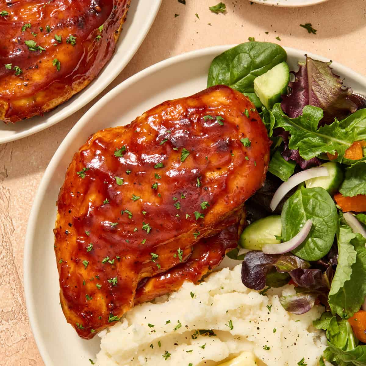 Air fryer barbecue chicken breast on plate with sides.