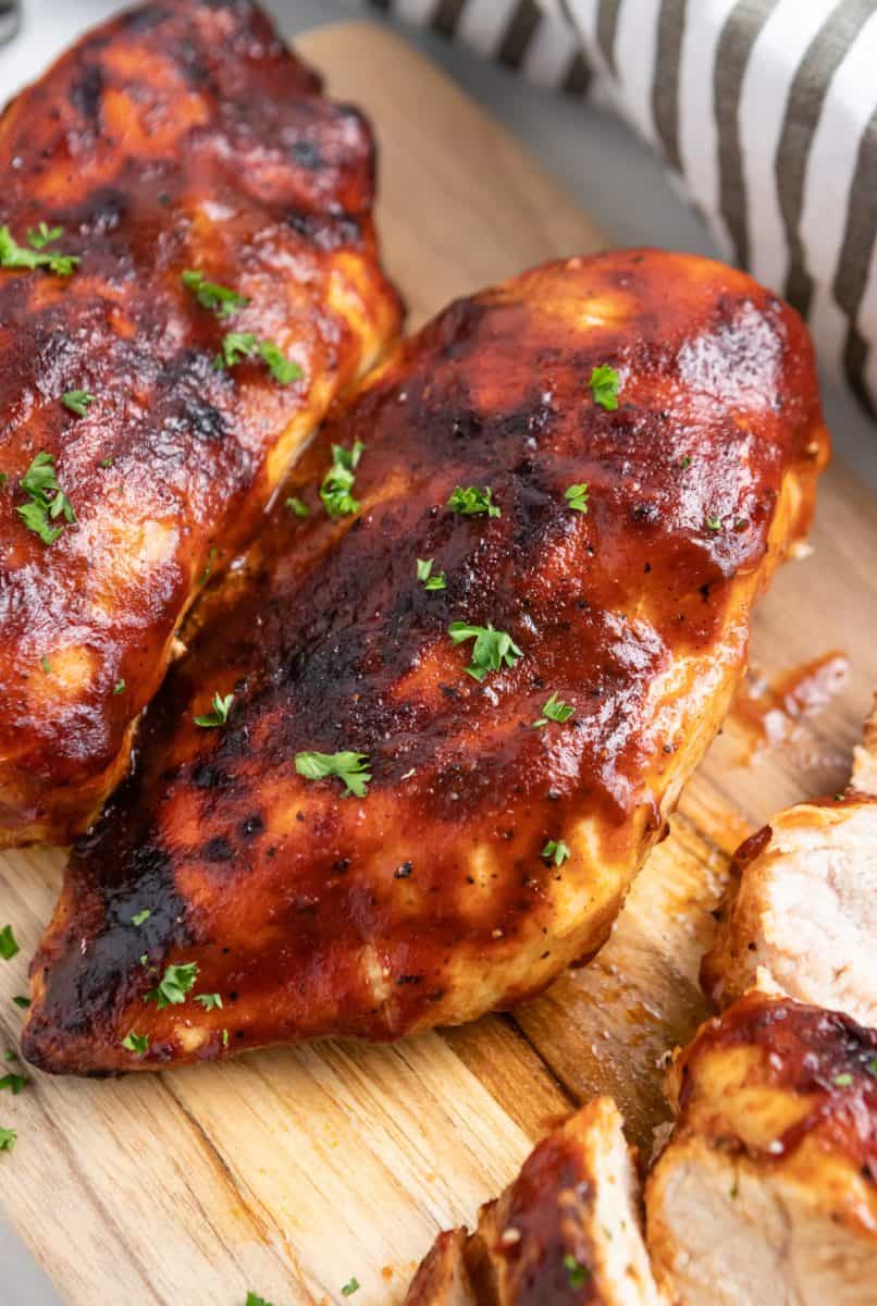 Chicken on cutting board with parsley.