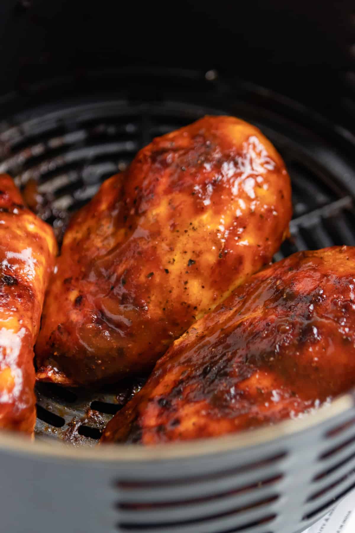 BBQ sauce on chicken in air fryer.