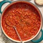 Ground turkey spaghetti sauce in pot with ladle.