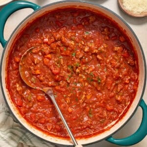 Ground turkey spaghetti sauce in pot with ladle.