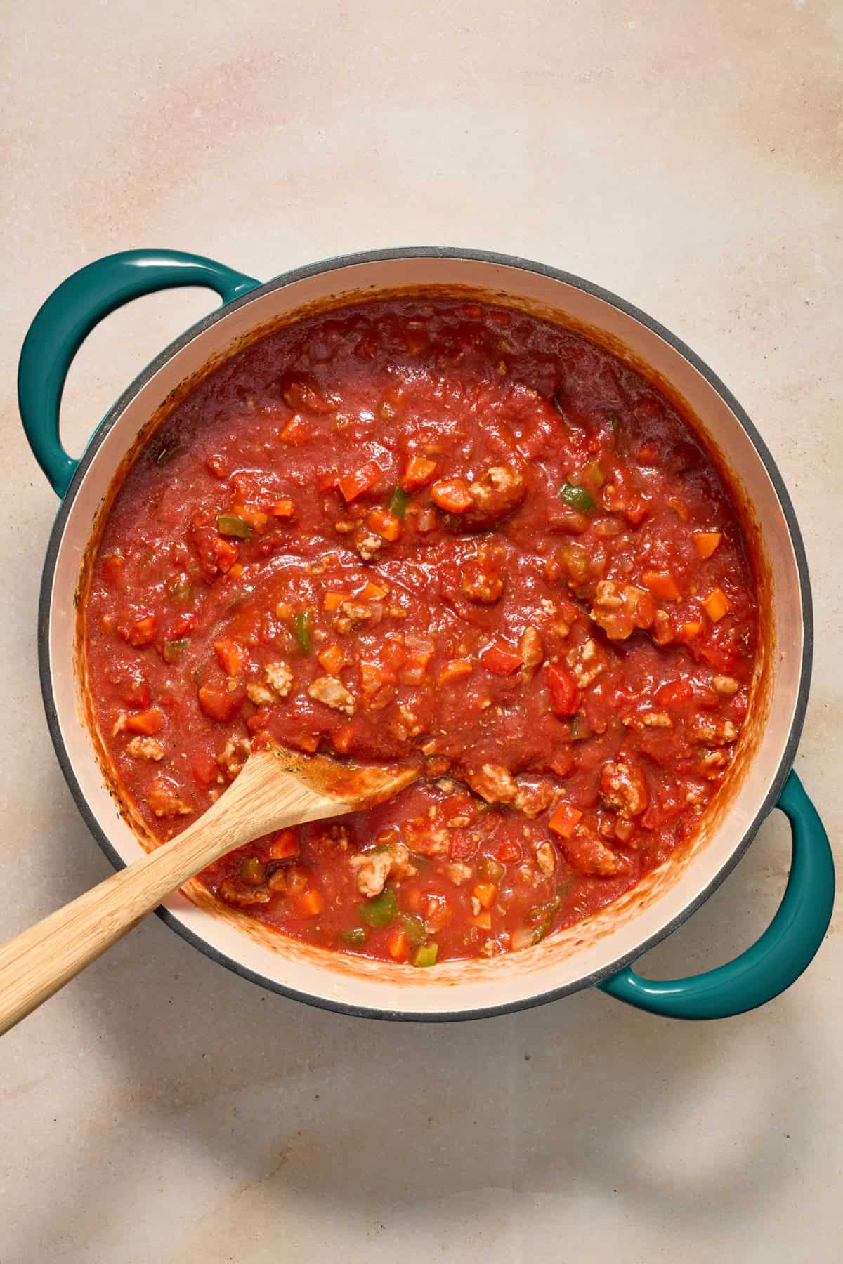 Ground turkey meat sauce in pot with spoon.