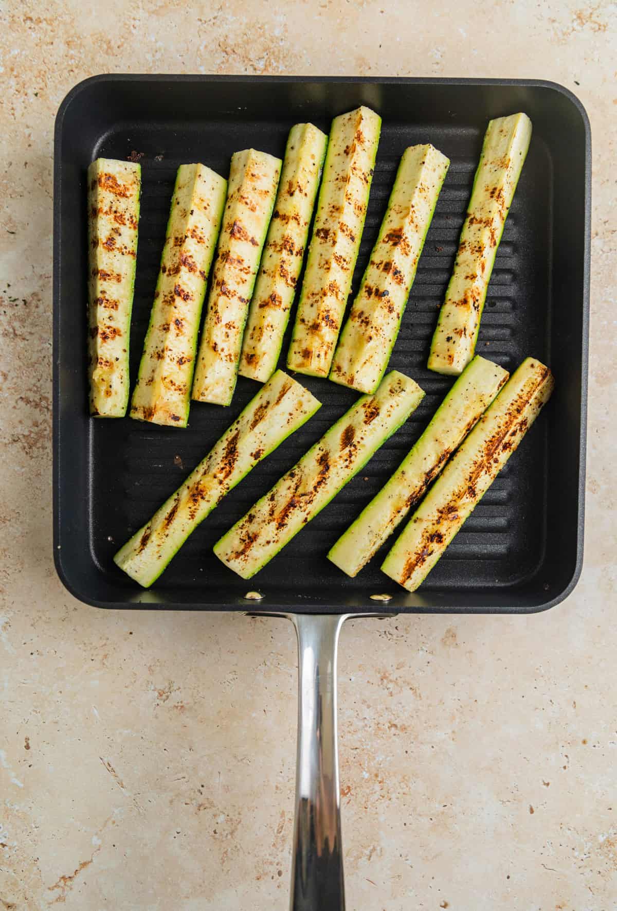 Zucchini pieces on grill pan.