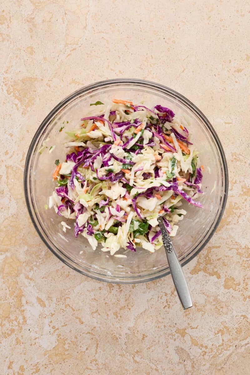 Cilantro lime slaw in bowl with spoon.