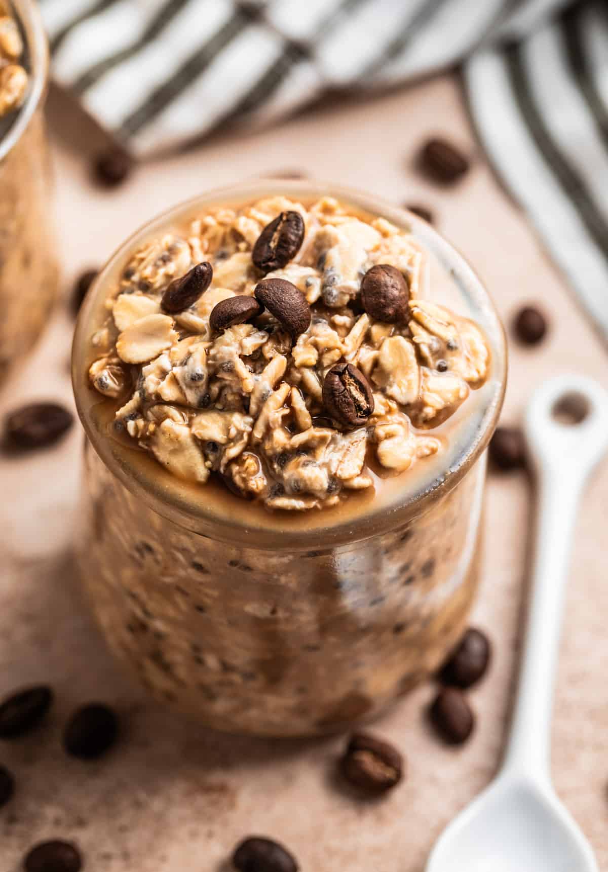 Overnight oatmeal in jar with coffee beans on top.