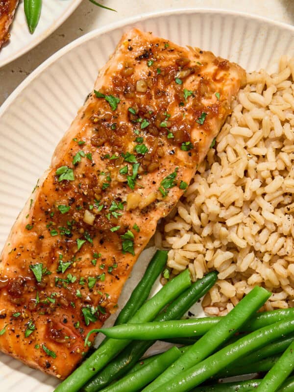 Maple citrus glazed salmon on plate with rice and vegetables.