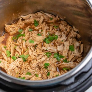 Shredded chicken with cilantro in Instant Pot.