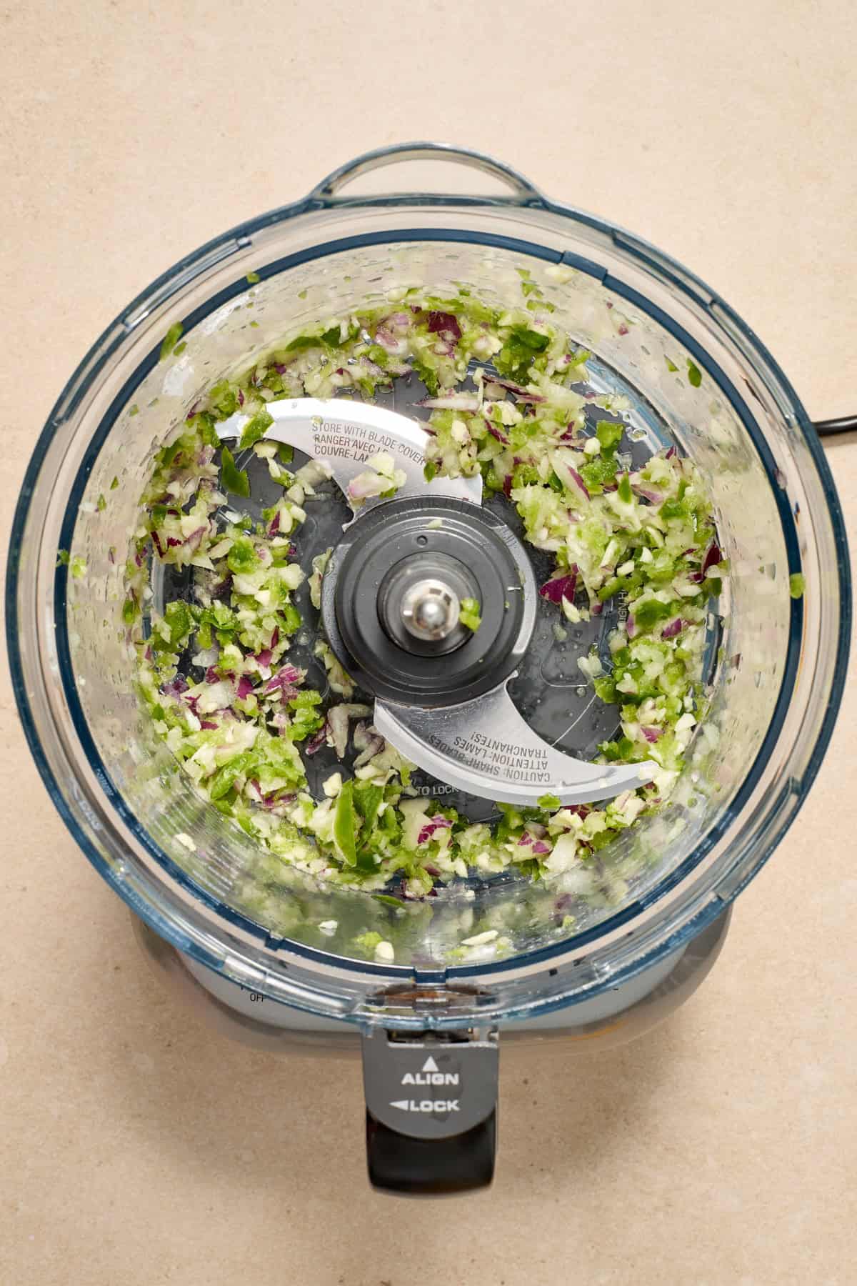 Chopped peppers and onions in food processor.