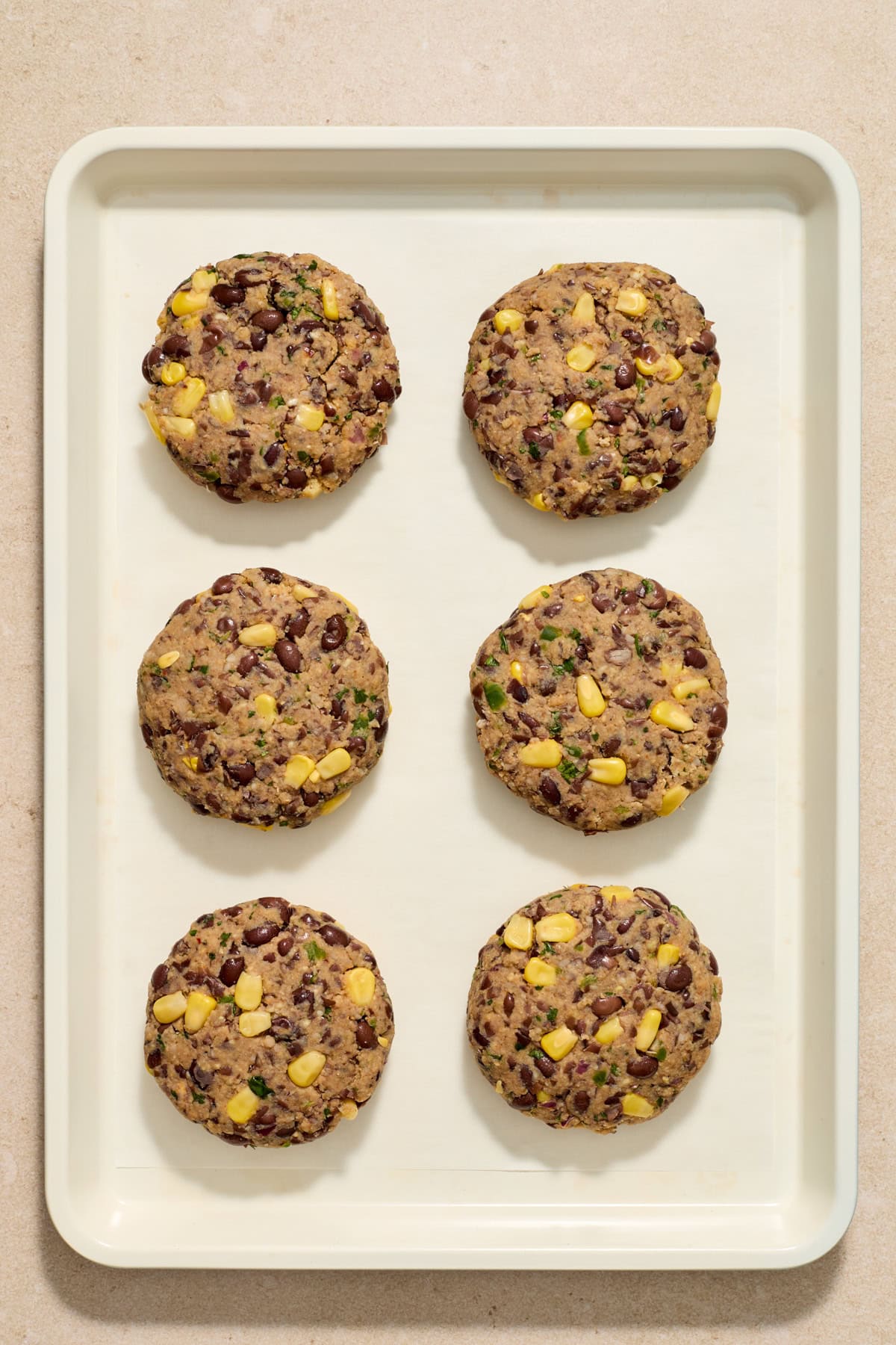 Formed black bean burgers formed on sheet pan.