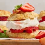 Layered biscuit, strawberries, peaches and whipped cream topped with fresh mint and berries.