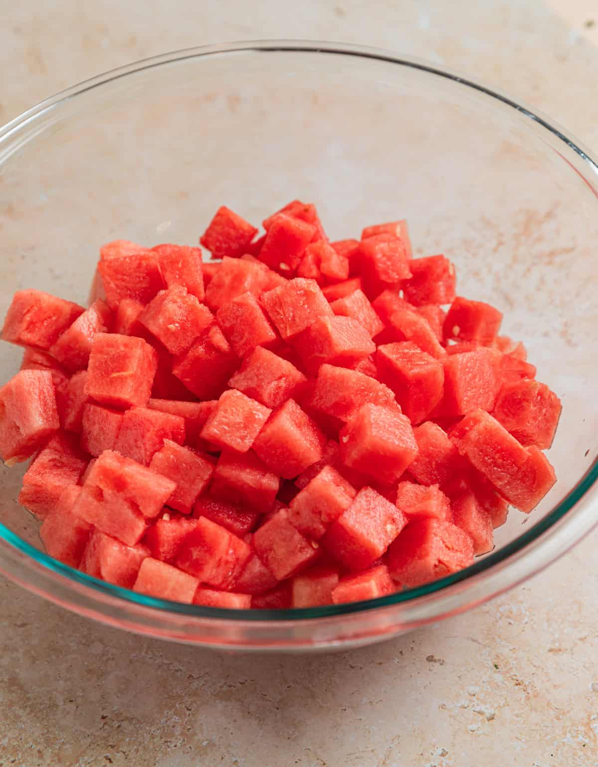 Cubed watermelon in glass bowl.