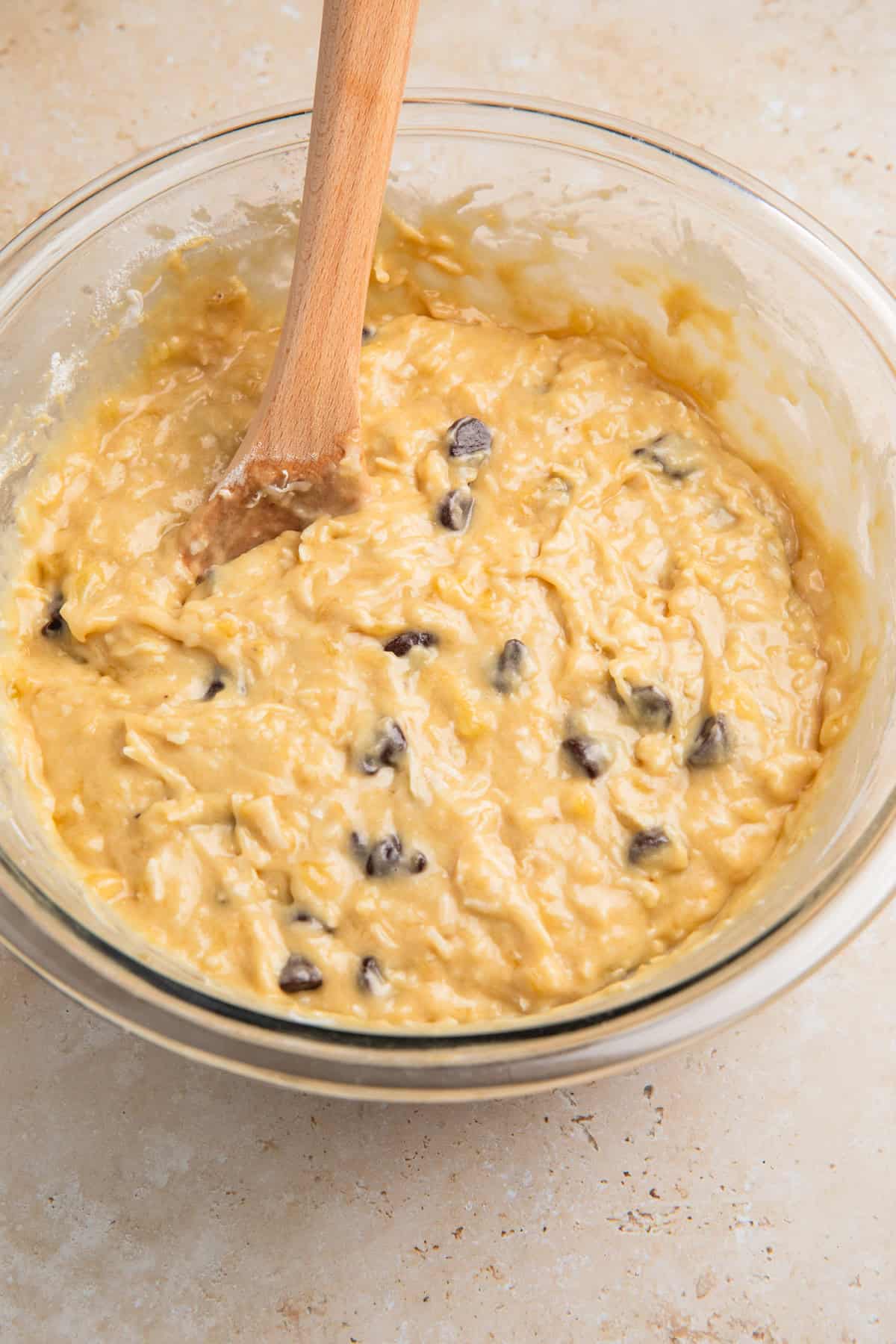 Coconut banana bread batter with chocolate chips in it.