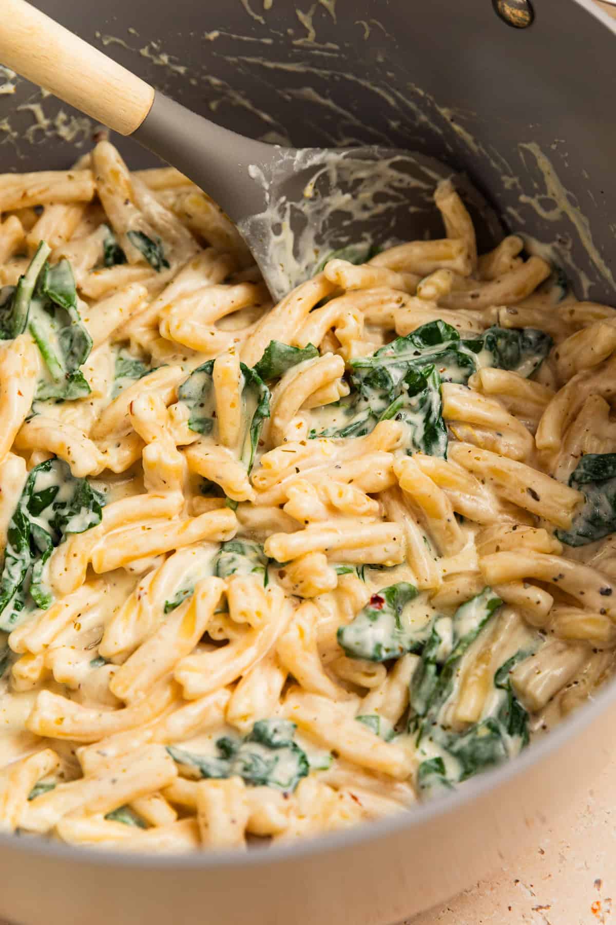 Lemon ricotta pasta in pot with spoon.