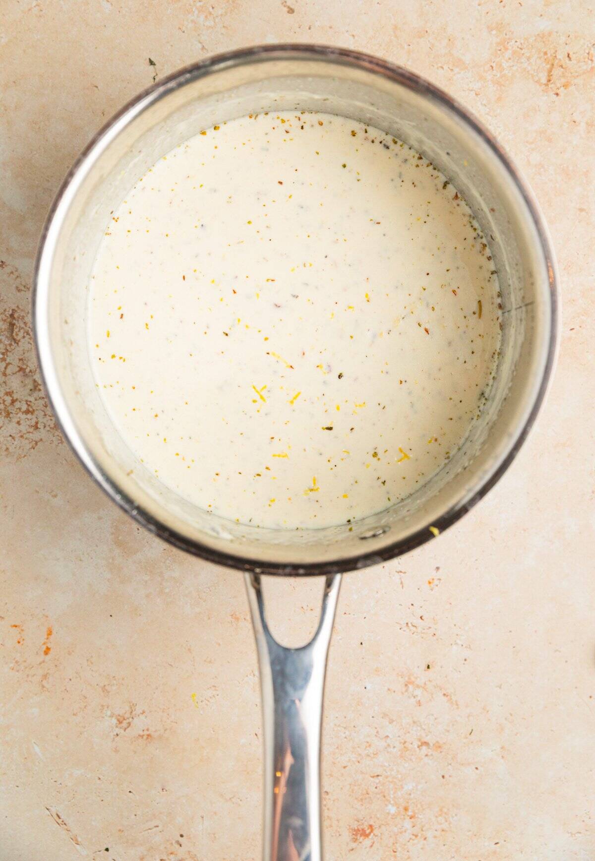 Creamy lemon ricotta sauce in saucepan.