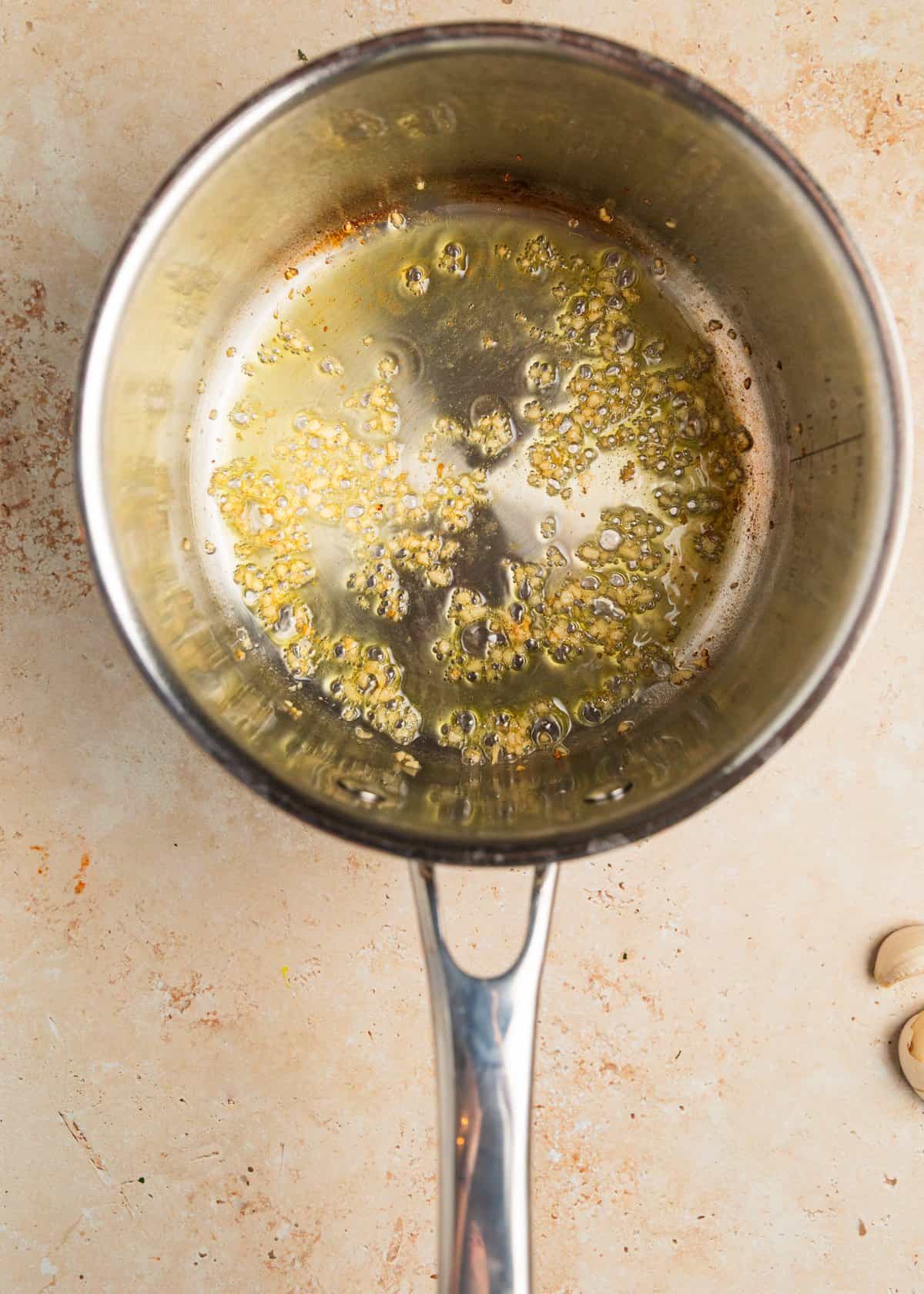 Garlic and olive oil in saucepan.
