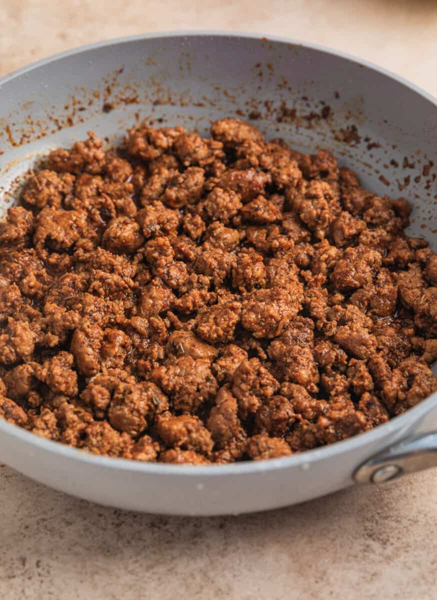 Ground pork taco meat cooked in skillet.