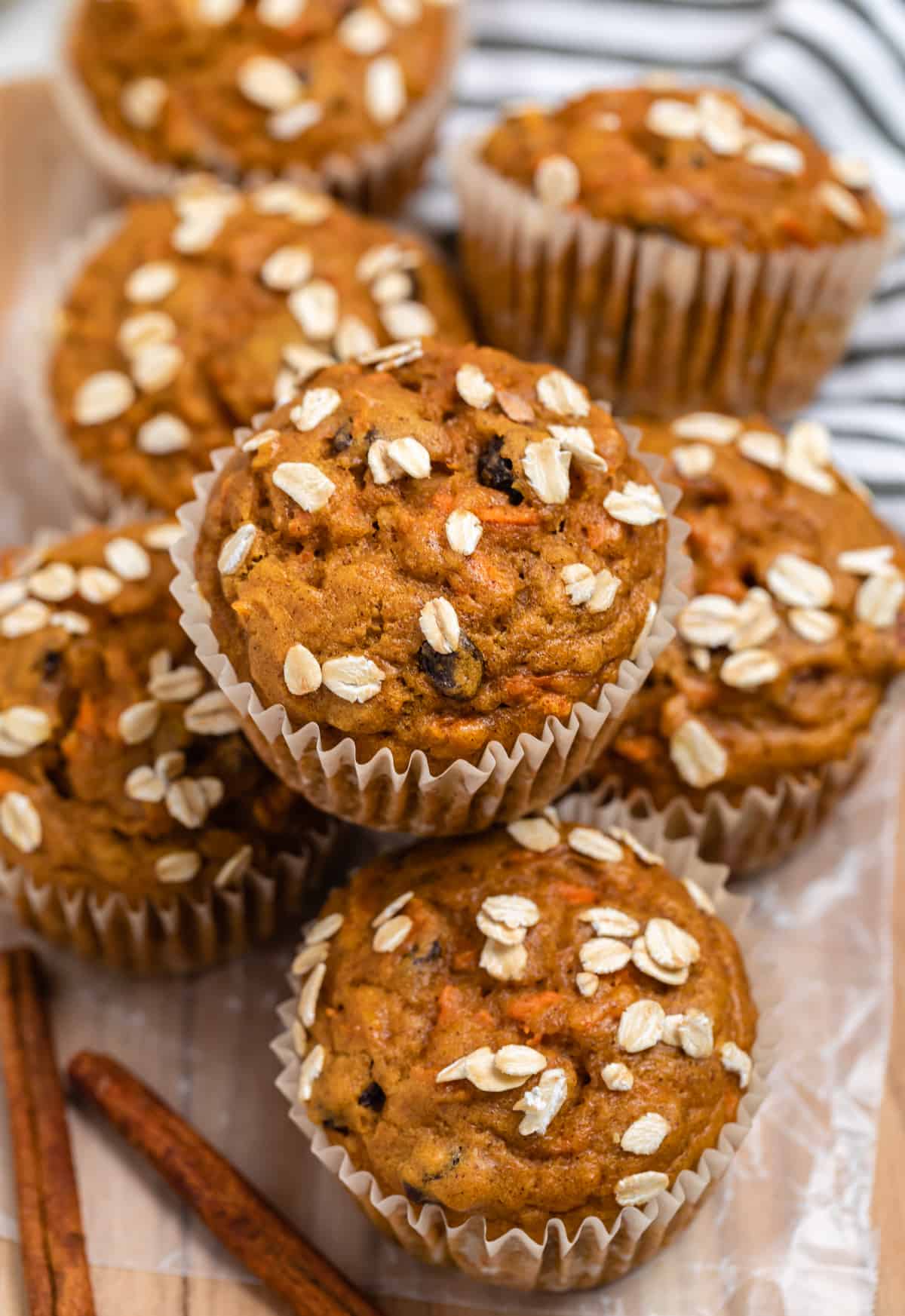 Pumpkin muffins with carrots and oats on top.