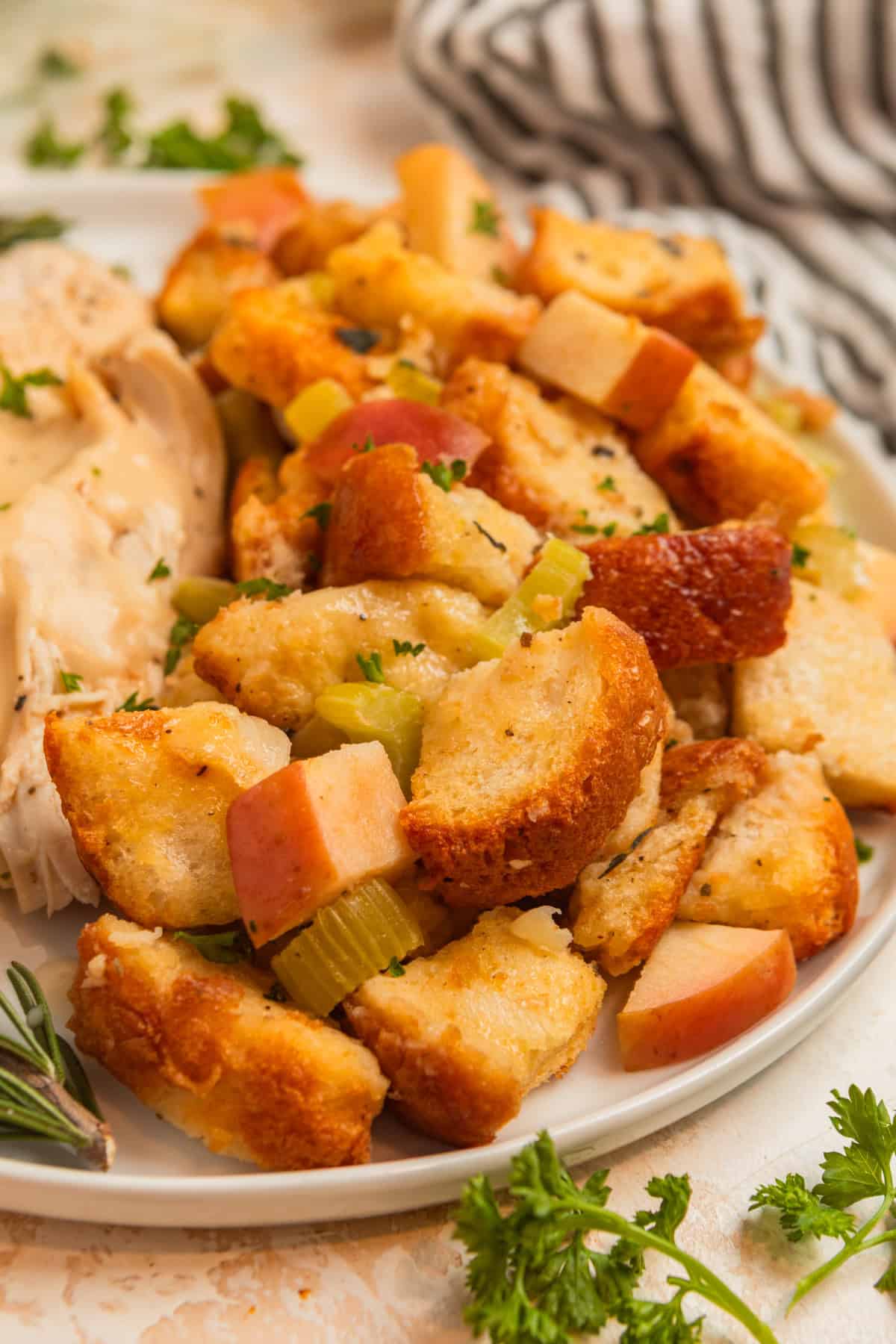 Apple sage stuffing on white plate with turkey.