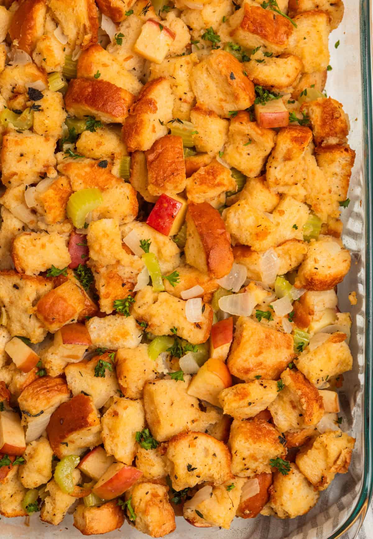 Pan with apple stuffing topped with freshly chopped parsley.