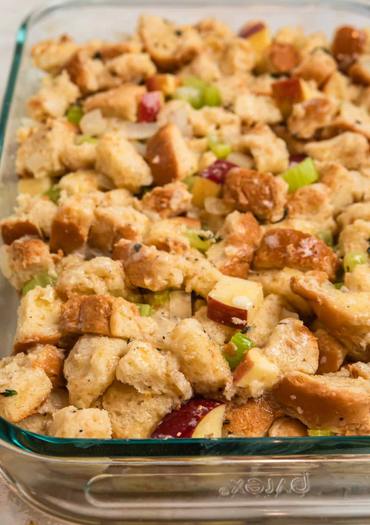 Glass pan with stuffing mixture ready to bake.