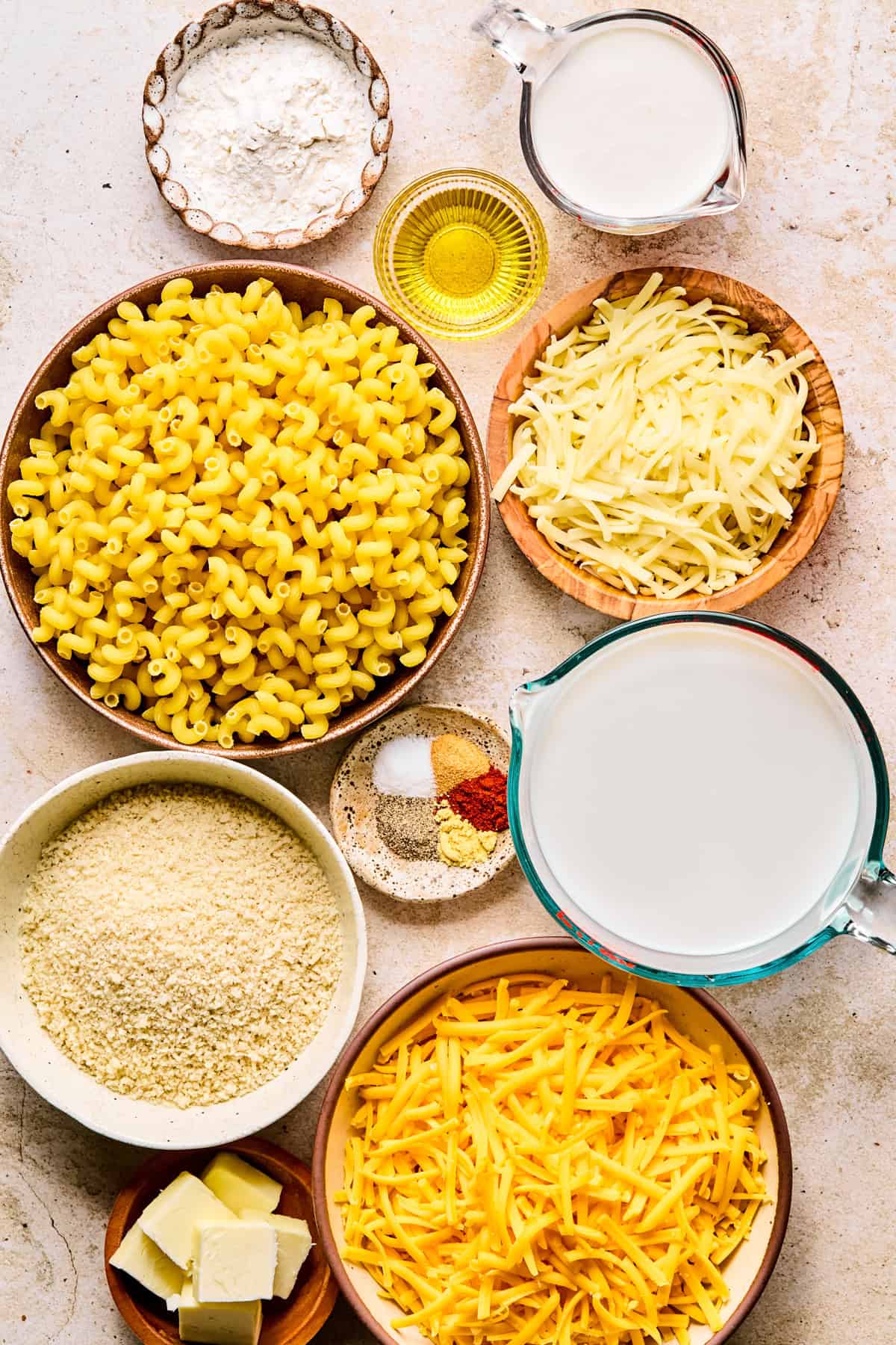 Pasta, shredded cheese, milk and other ingredients to make recipe.