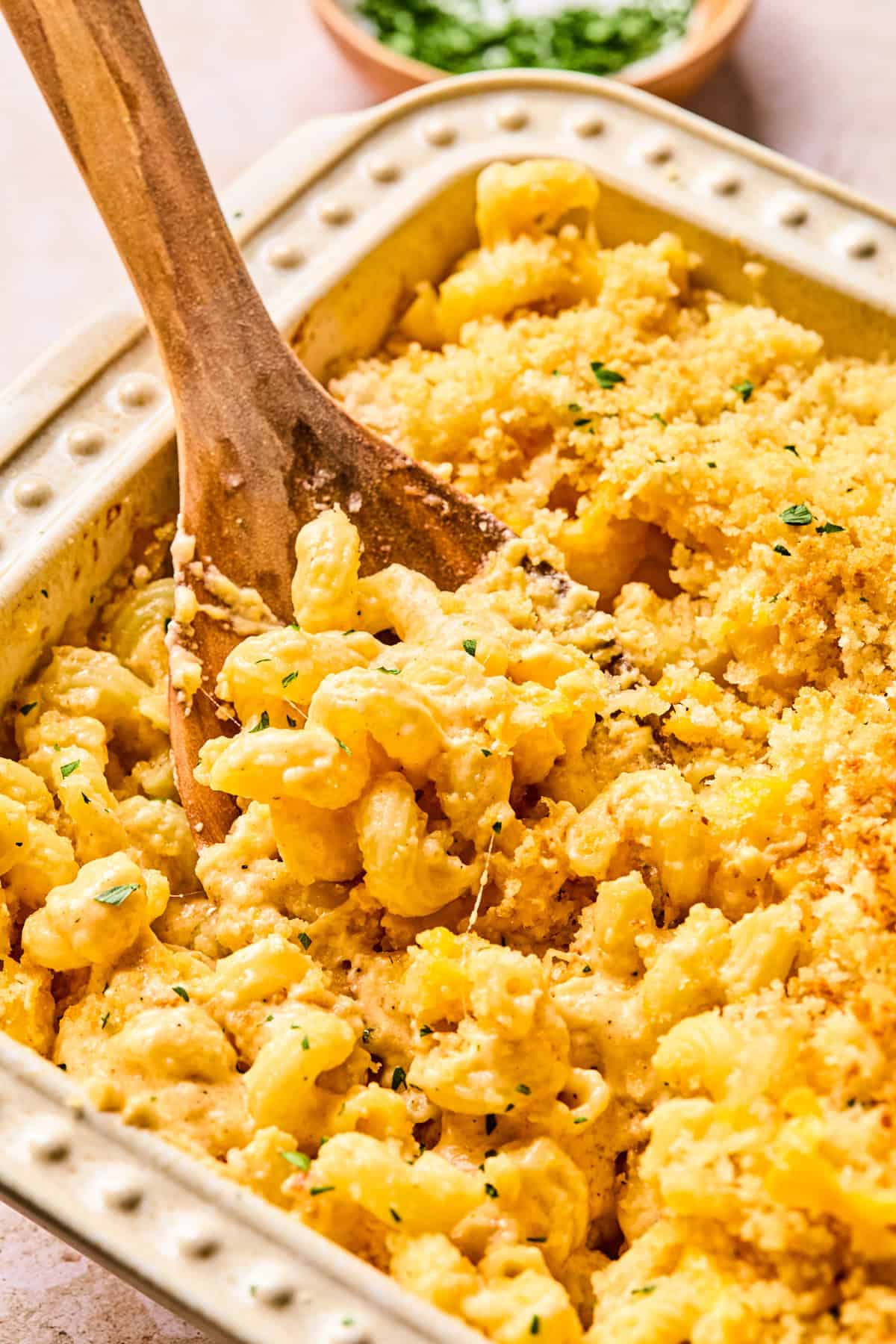 Pan of baked mac and cheese with serving spoon.