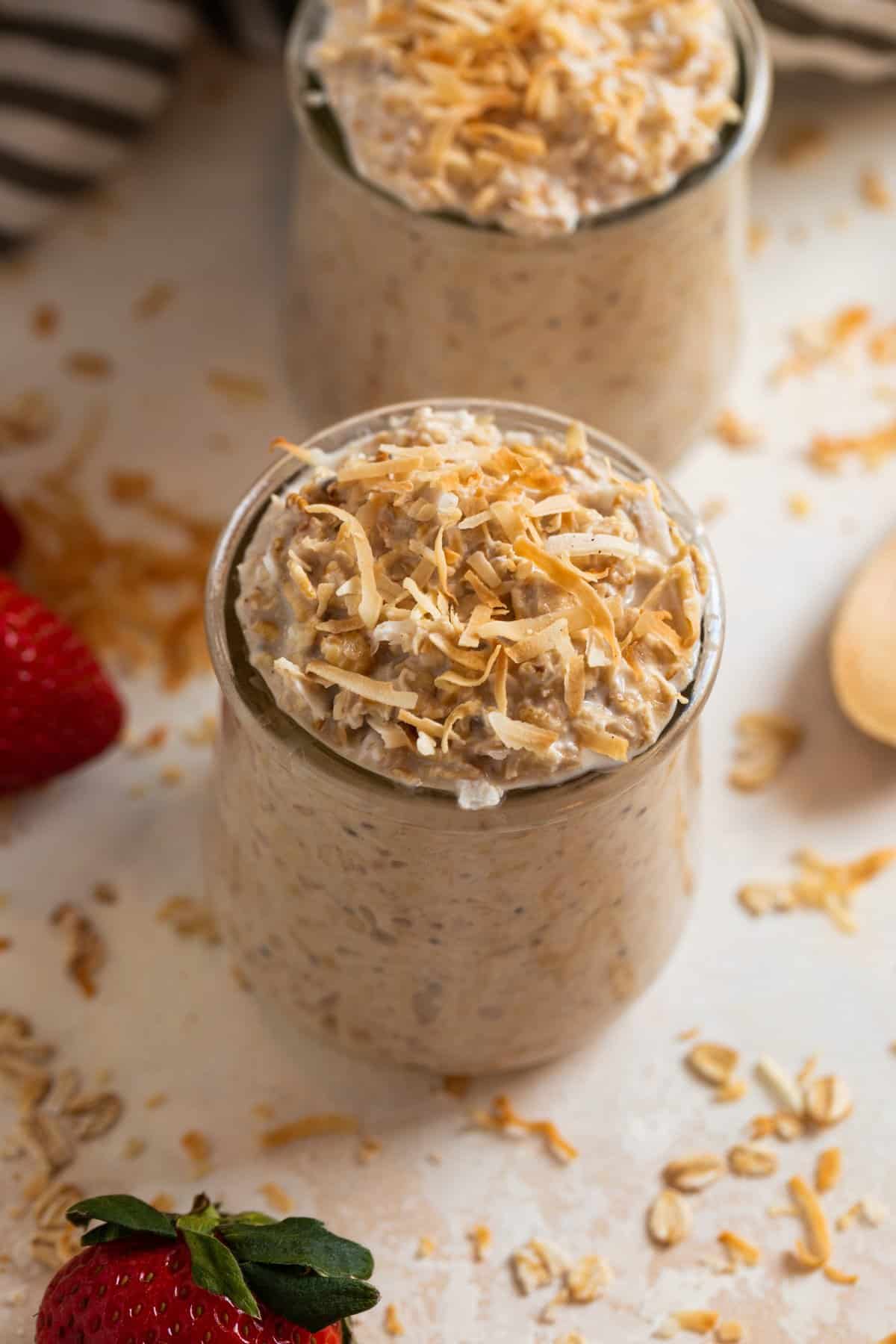 Jar of overnight oatmeal with coconut shredded over top.