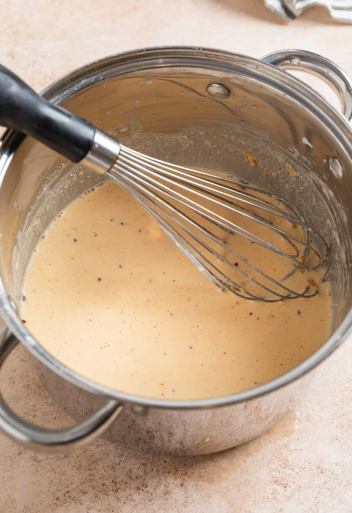 Whisk in large pot with mac and cheese sauce.