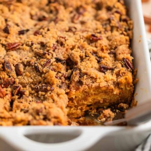 Casserole dish with baked brioche French toast casserole topped with pecan streusel.