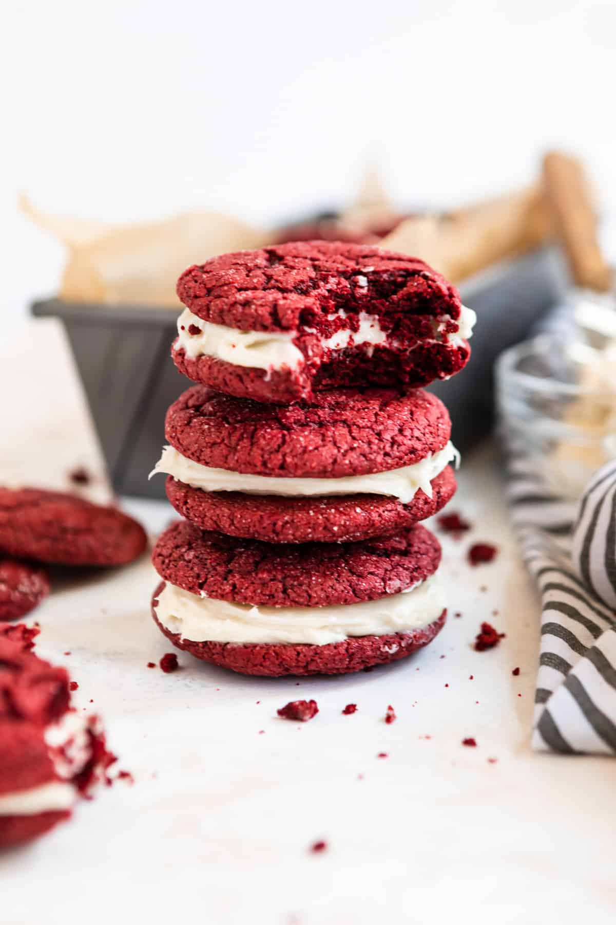 Stack of red velvet cake mix cookies with cream cheese icing.