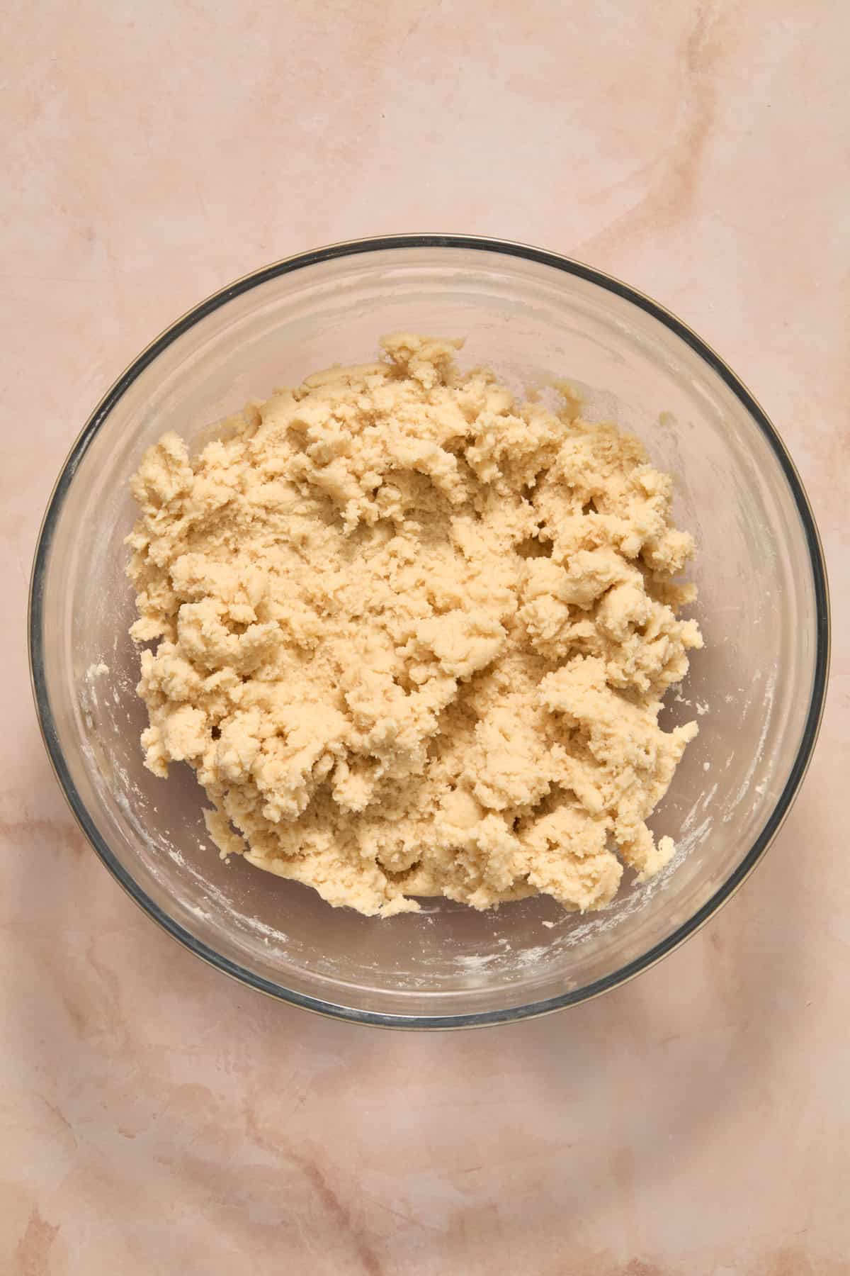 Flour and dry ingredients mixed into wet ingredients for sugar cookie recipe.