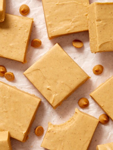 Microwave peanut butter fudge cut into squares and arranged on wax paper.