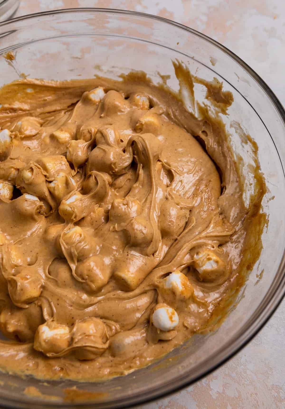 Peanut butter fudge mixed in bowl with marhsmallows.